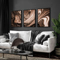 Contemporary living room with three framed copper wall art prints above a cream sofa