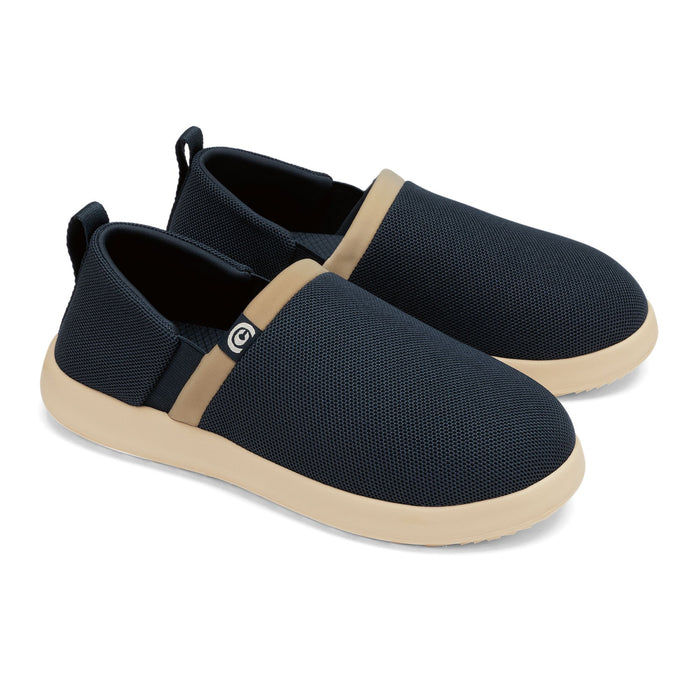 Pair of black slip-on shoes with beige accents on a white background #color_navy