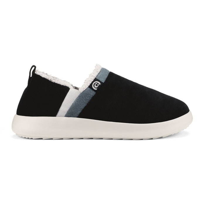 A single slip-on shoe shown in profile against a white background. The shoe has a black upper, a light gray and white vertical stripe, a white faux-fur lining at the collar, and a thick white sole. #color_black