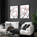 Modern living room pictures for wall featuring two framed pink blossom branch artworks above white sofa