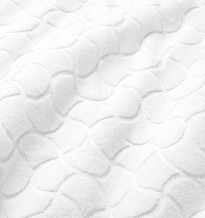 Close-up of textured oasi white bath linens