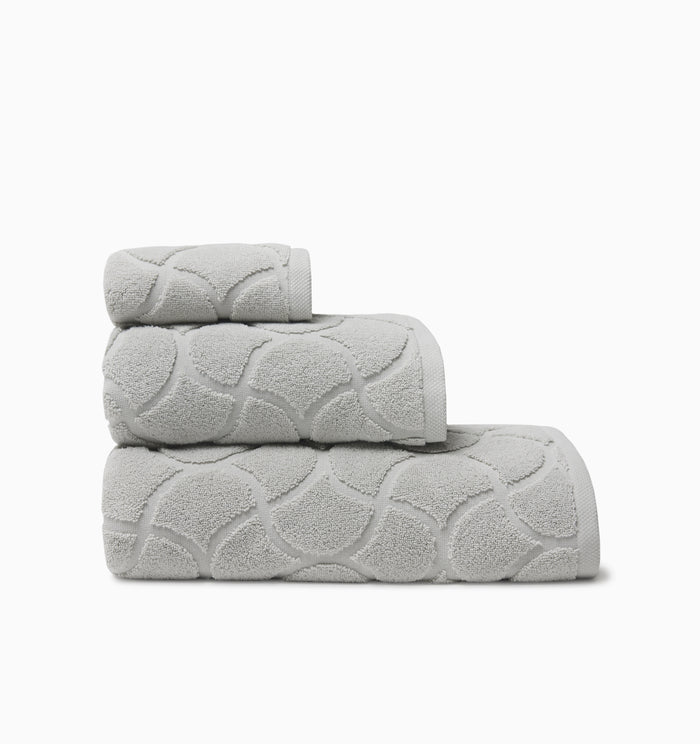 Oasi platinum bath towel, hand towel, and wascloth folded and stacked side view