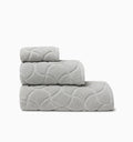 Oasi platinum bath towel, hand towel, and wascloth folded and stacked side view