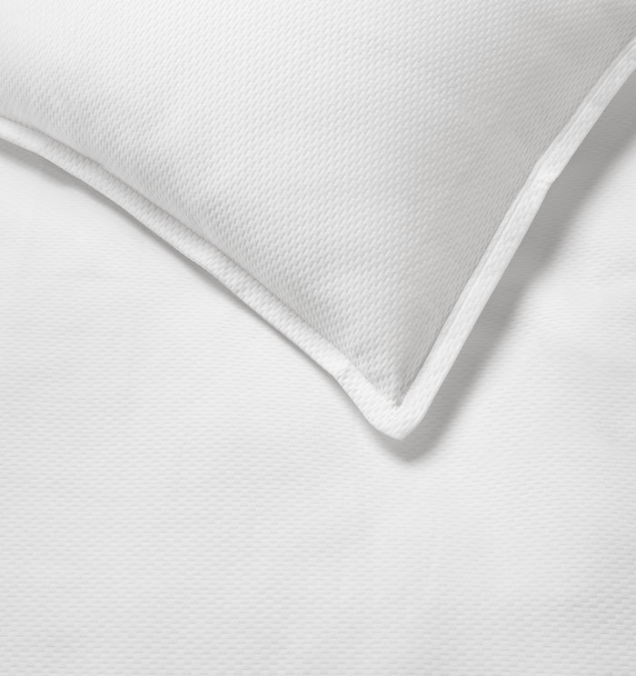 Close up of the Perrio white coverlet and sham