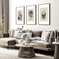 Three framed abstract geometric pictures for living room above a grey sectional sofa