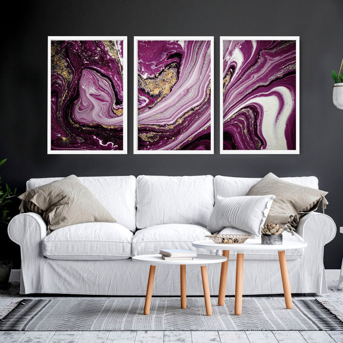Three framed purple marble abstract prints displayed above a white sofa in a modern bedroom setting