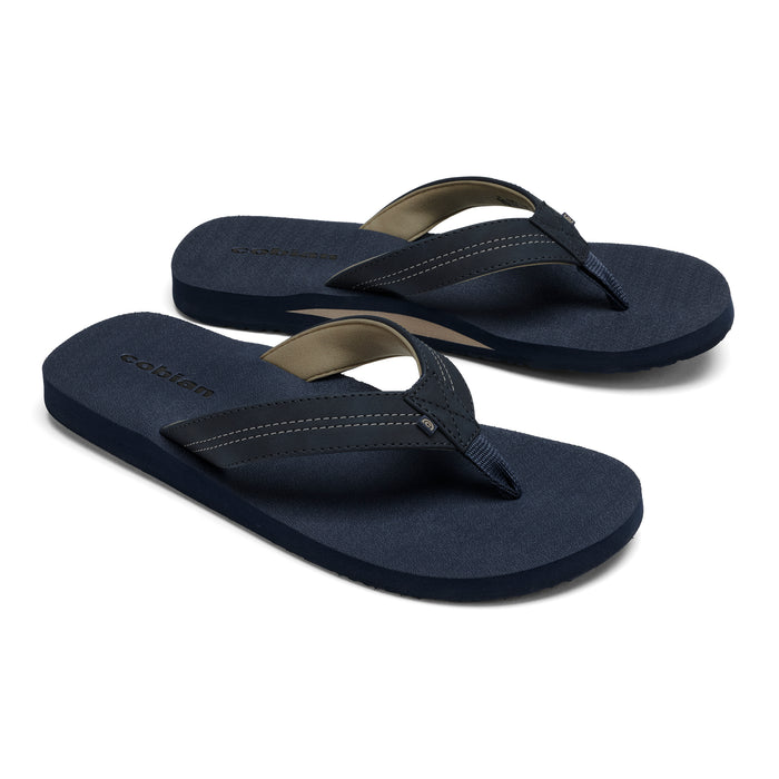Pair of navy blue flip-flops with a brand logo on a white background #color_navy