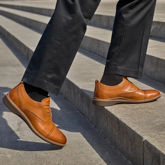 The Cap-Toe in Honey Tan worn by model in dark dress pants
