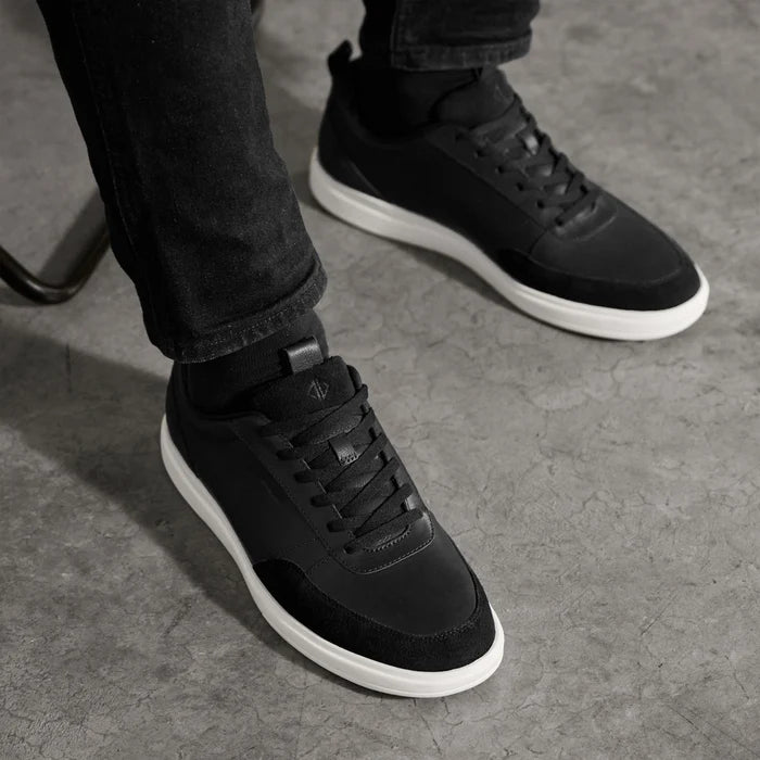 Model wearing The Court in Onyx leather & suede with black pants and gray sweater