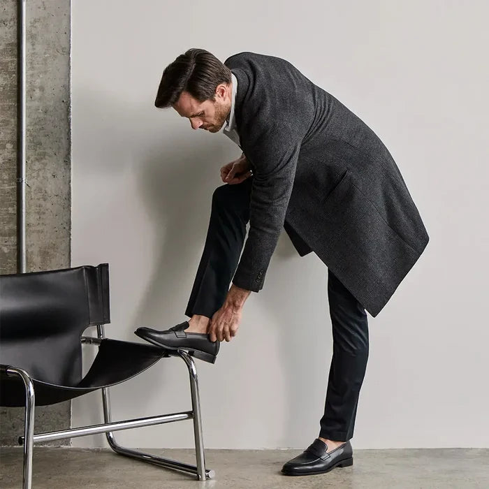 Model wearing The Duke in Obsidian black full-grain leather with dark dress pants and overcoat