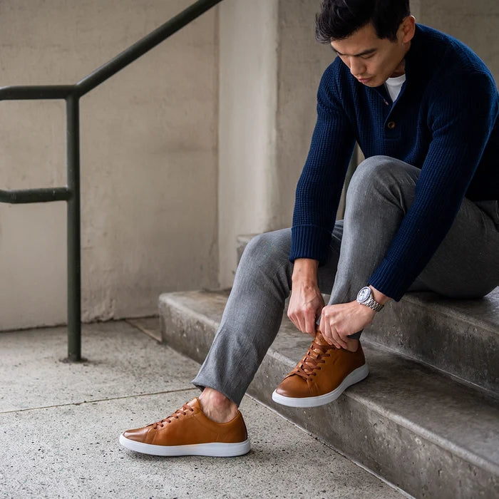 The Low-Top in Honey tan leather by Amberjack - worn by model with gray dress pants and blue sweater