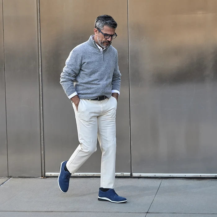 Model wearing The Original in Cobalt blue suede paired with light dress pants and gray sweater